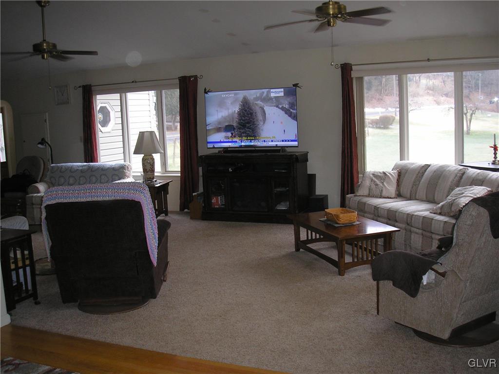 5785 Haasadahl Road Orefield, PA 18069 - Photo 9 of 28 a living room with furniture a flat screen tv and a fireplace