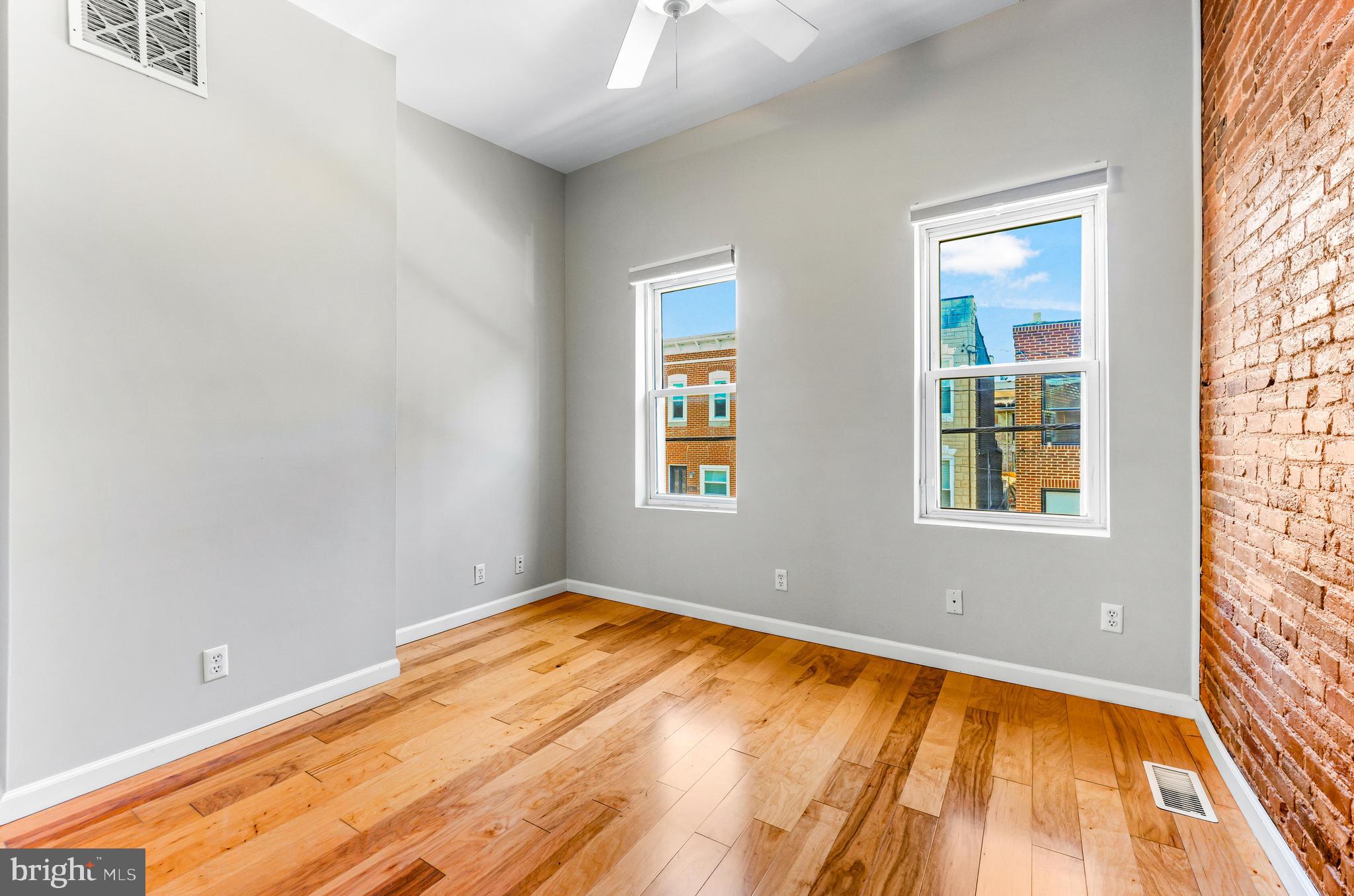 1432 Haubert Street Baltimore, MD 21230 - Photo 12 of 28 a view of an empty room with wooden floor and a window
