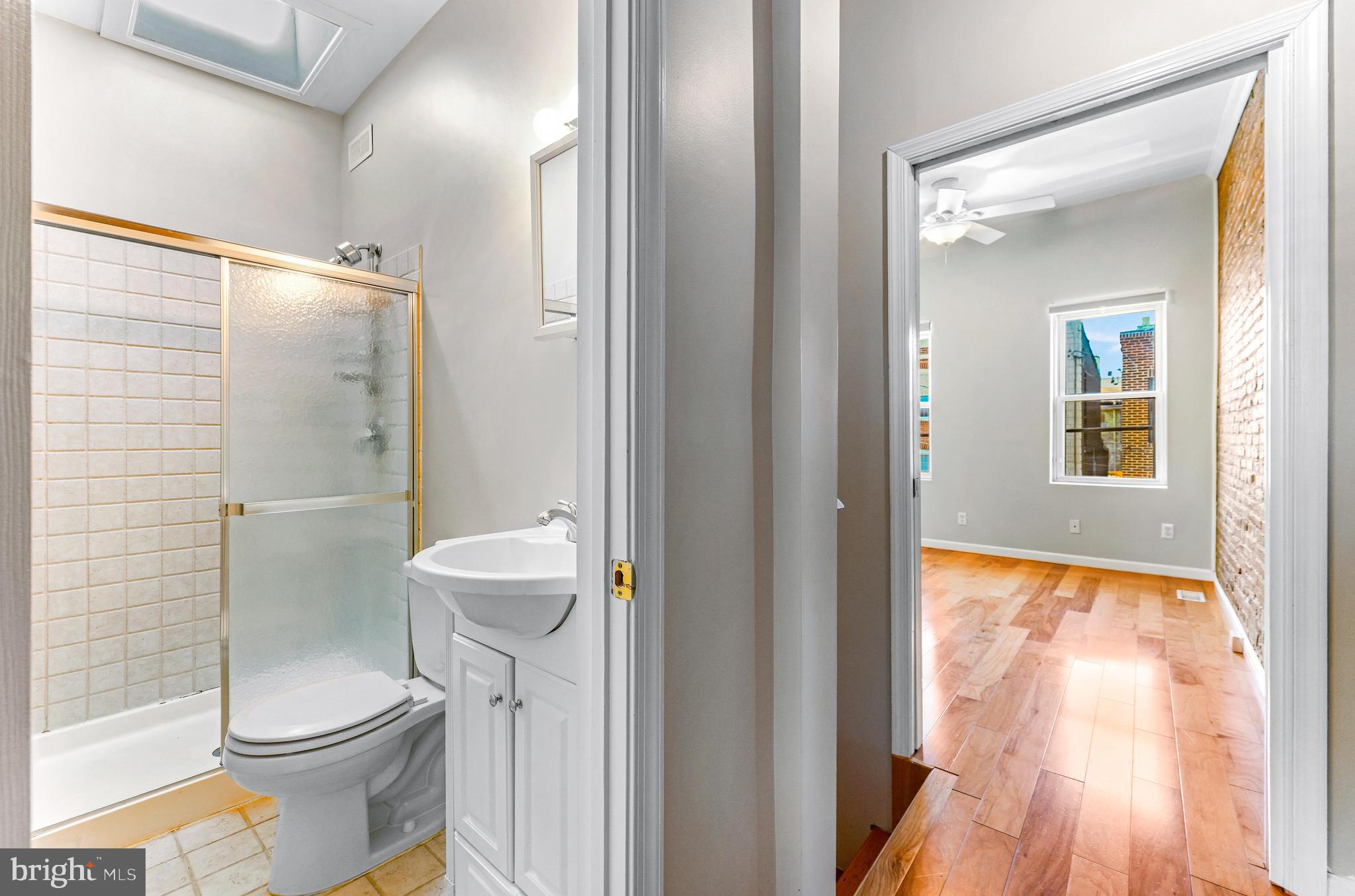 1432 Haubert Street Baltimore, MD 21230 - Photo 13 of 28 a bathroom with a toilet and a shower