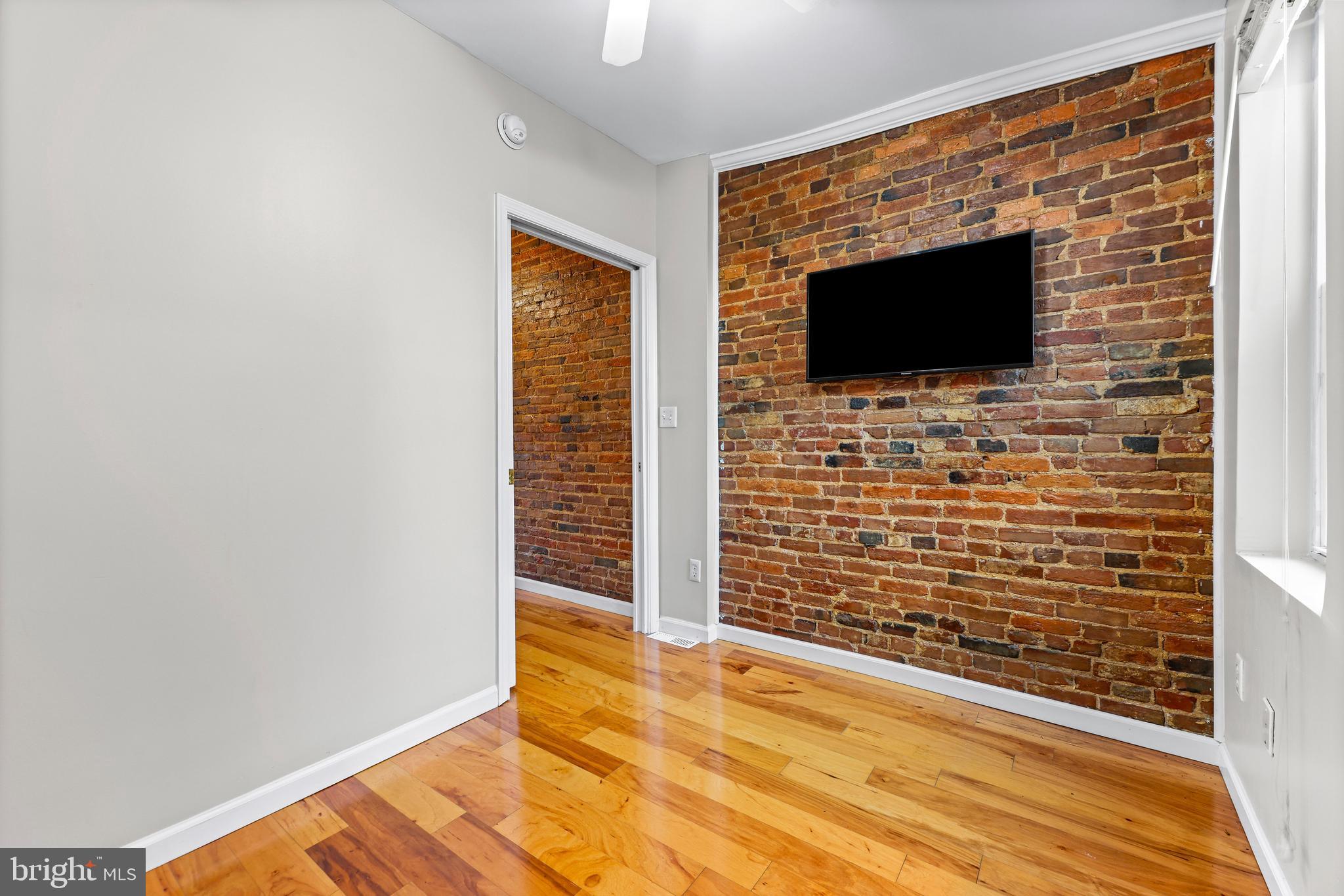 1432 Haubert Street Baltimore, MD 21230 - Photo 16 of 28 a view of empty room with wooden floor and a ceiling fan
