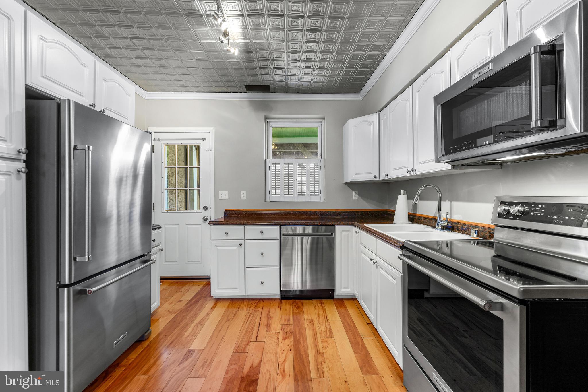 1432 Haubert Street Baltimore, MD 21230 - Photo 5 of 28 a kitchen with stainless steel appliances a stove microwave and sink