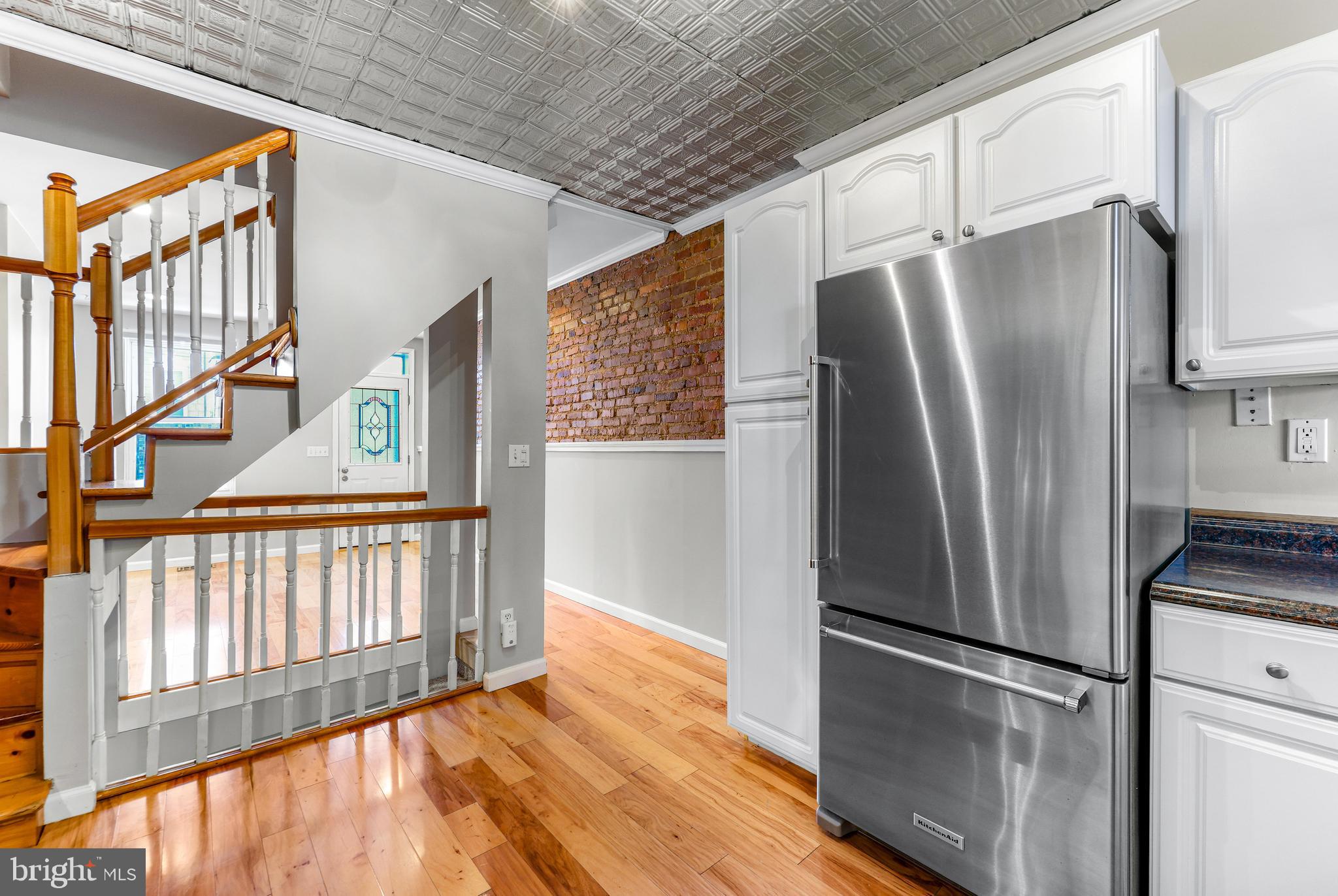 1432 Haubert Street Baltimore, MD 21230 - Photo 7 of 28 a view of a refrigerator in kitchen and wooden floor
