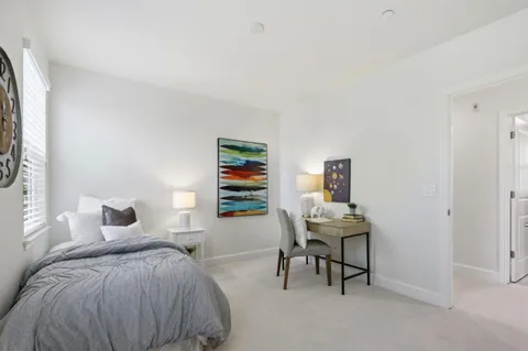 a bedroom with a bed and a desk