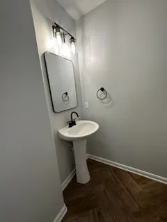 a bathroom with a sink and mirror