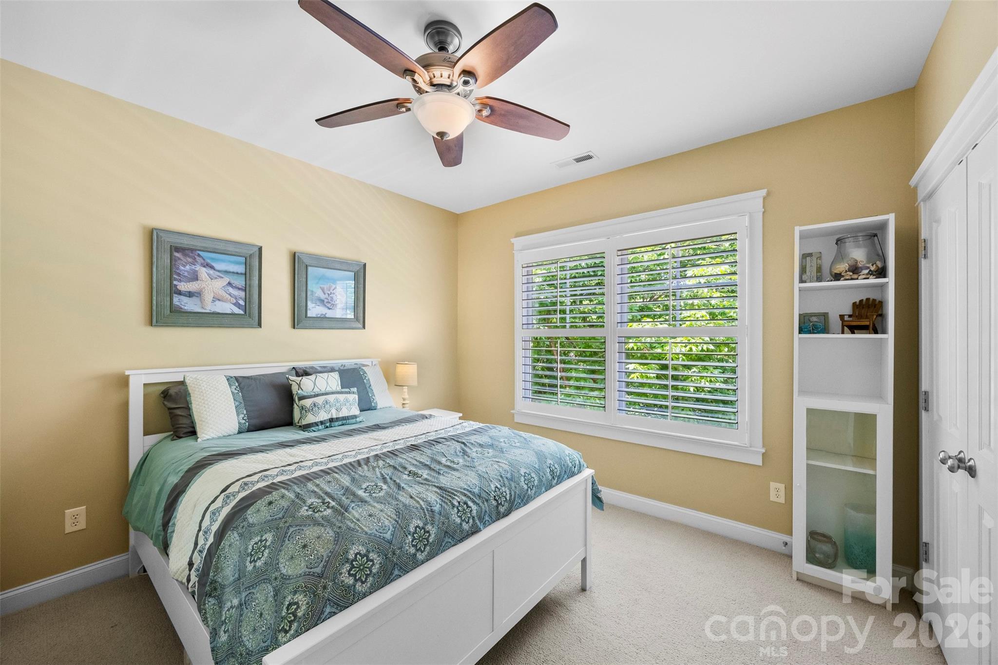 606 Andover Lane Tega Cay, SC 29708 - Photo 25 of 48 a bedroom with a large bed and a chandelier fan
