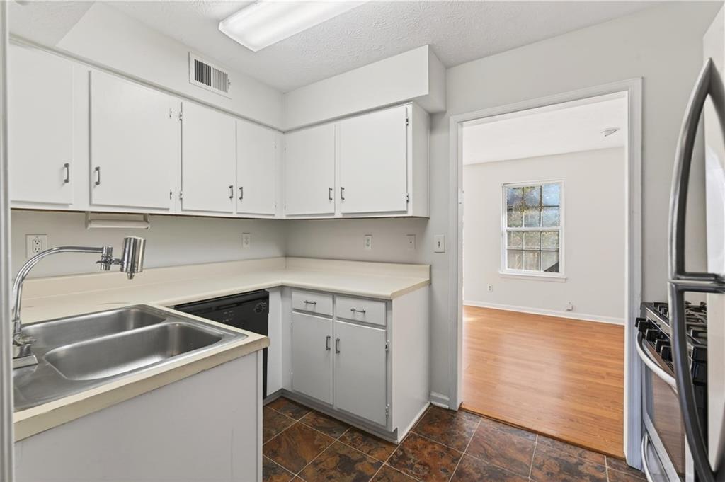 263 Quail Run Roswell, GA 30076 - Photo 13 of 47 a kitchen with white cabinets and sink