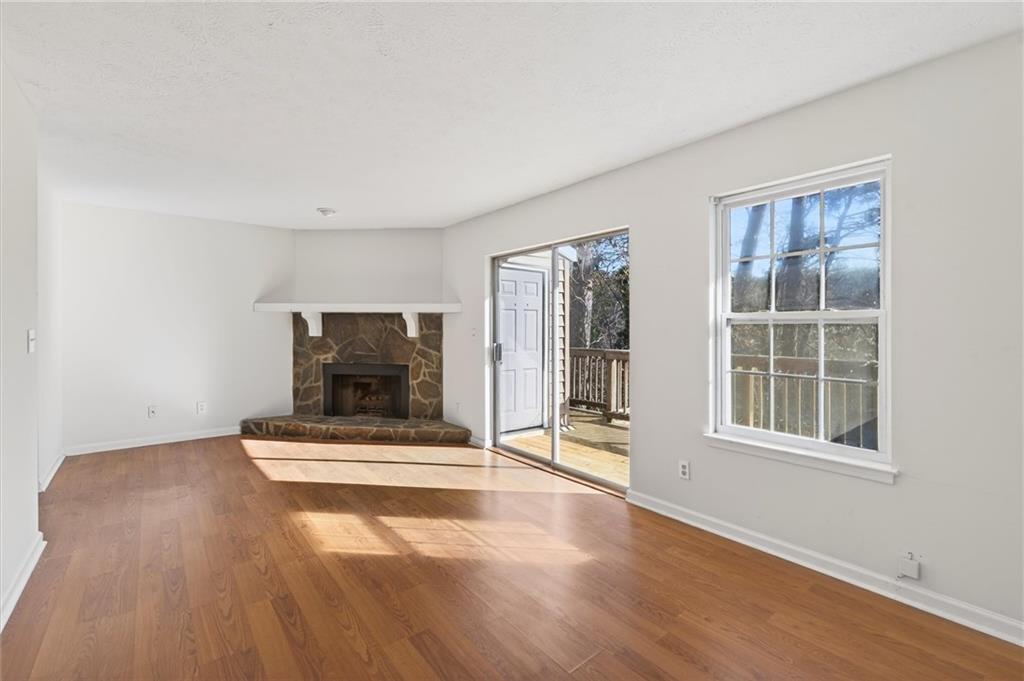 263 Quail Run Roswell, GA 30076 - Photo 16 of 47 an empty room with floor to ceiling window and wooden floor
