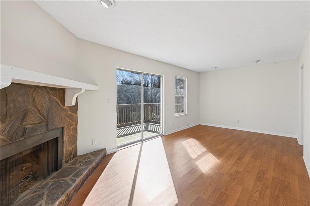 263 Quail Run Roswell, GA 30076 - Photo 18 of 47 a view of a livingroom with wooden floor and a fireplace