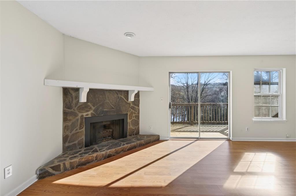 263 Quail Run Roswell, GA 30076 - Photo 19 of 47 a living room with a fireplace furniture and a floor to ceiling window