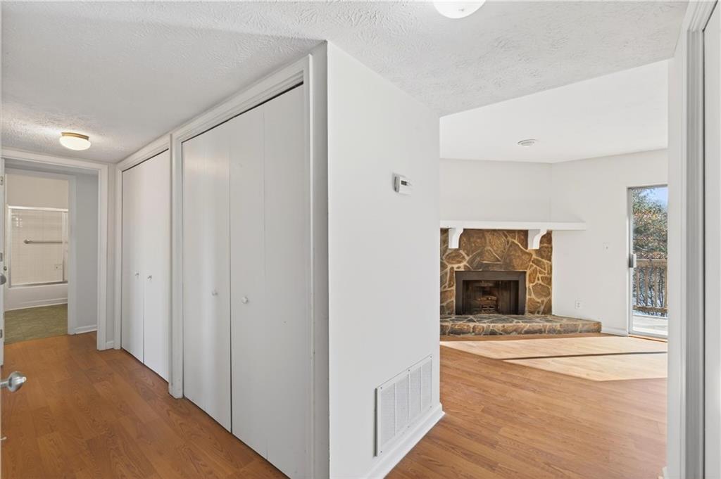 263 Quail Run Roswell, GA 30076 - Photo 25 of 47 a view of a hallway to a room with wooden floor cabinet and a living room