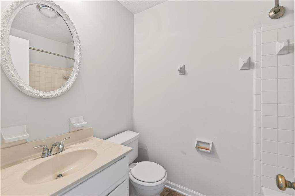 263 Quail Run Roswell, GA 30076 - Photo 27 of 47 a bathroom with a toilet sink vanity and mirror