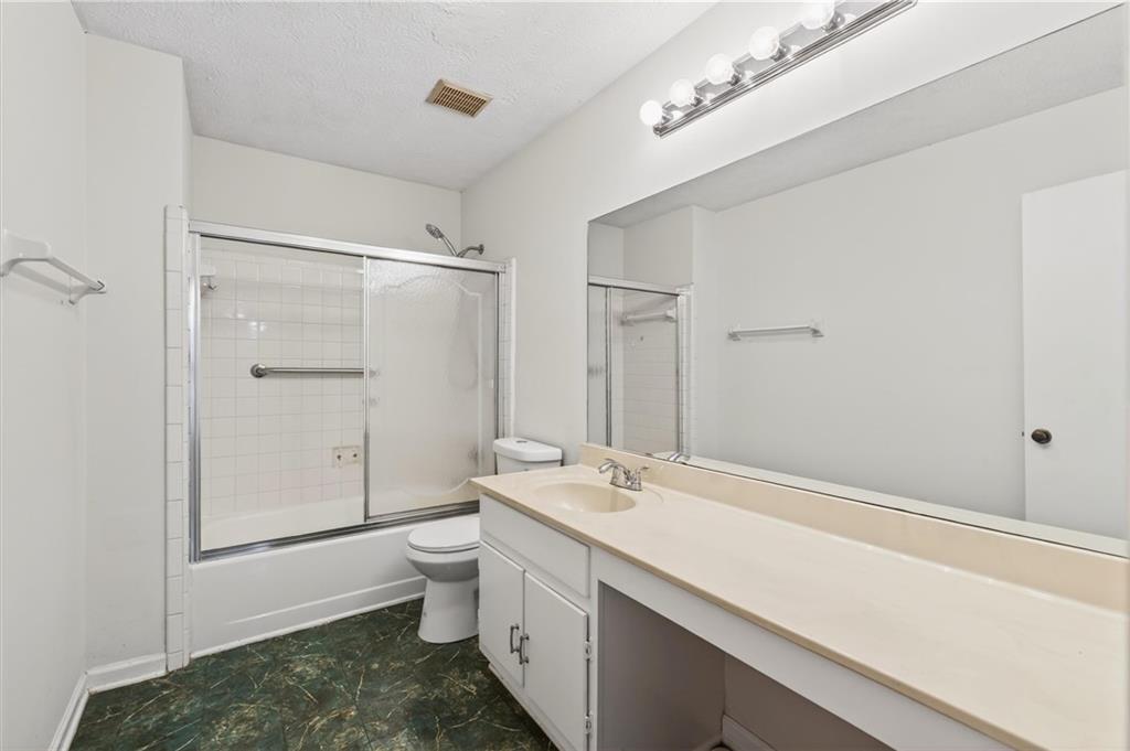 263 Quail Run Roswell, GA 30076 - Photo 30 of 47 a bathroom with a sink a toilet and shower