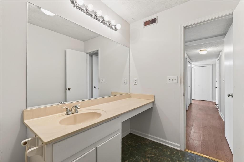263 Quail Run Roswell, GA 30076 - Photo 31 of 47 a bathroom with a sink and a mirror