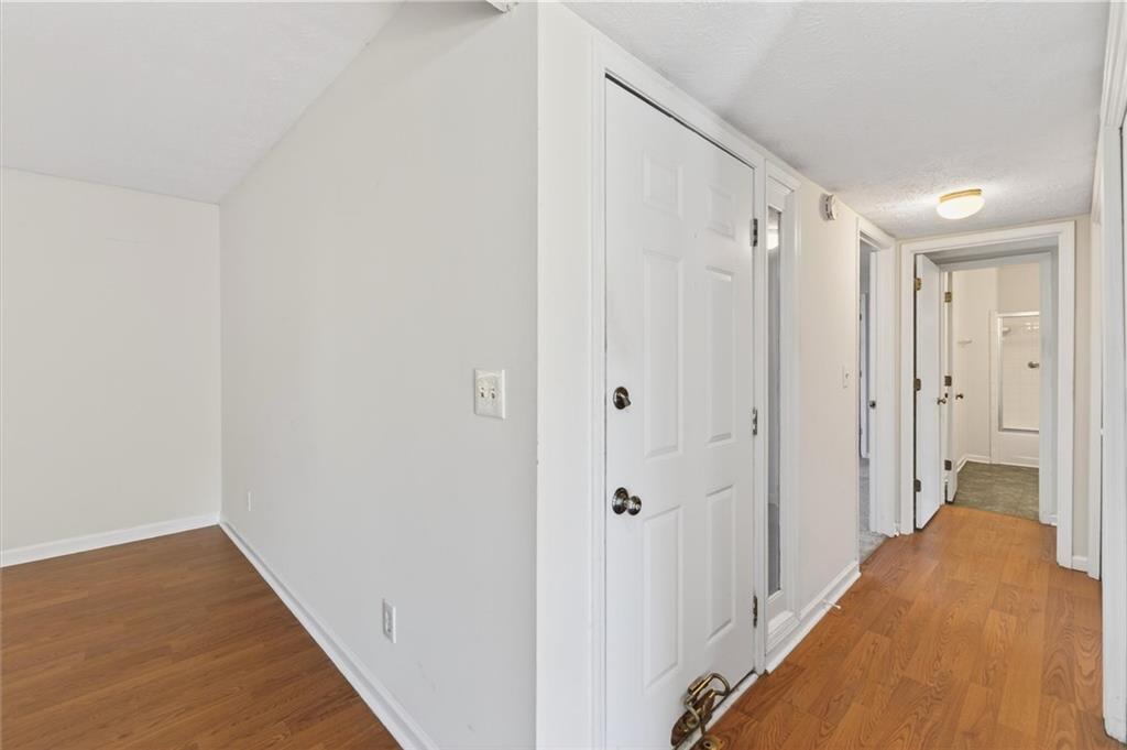 263 Quail Run Roswell, GA 30076 - Photo 5 of 47 a view of a hallway with wooden floor and a bathroom