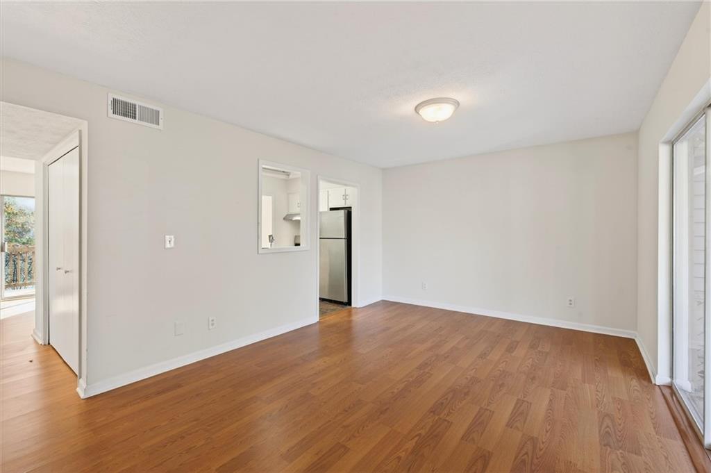 263 Quail Run Roswell, GA 30076 - Photo 6 of 47 wooden floor in an empty room with a window
