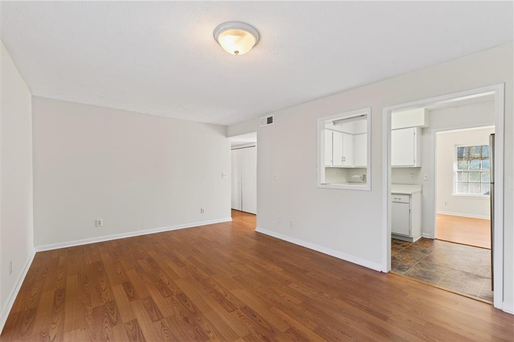 263 Quail Run Roswell, GA 30076 - Photo 8 of 47 an empty room with wooden floor and windows