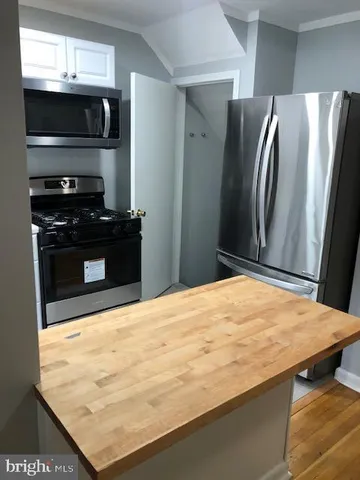 a kitchen with stainless steel appliances wooden cabinets and granite counter tops