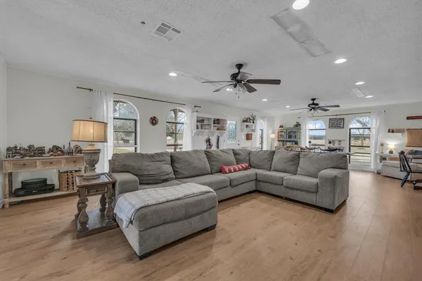 a living room with furniture or kitchen view and a wooden floor