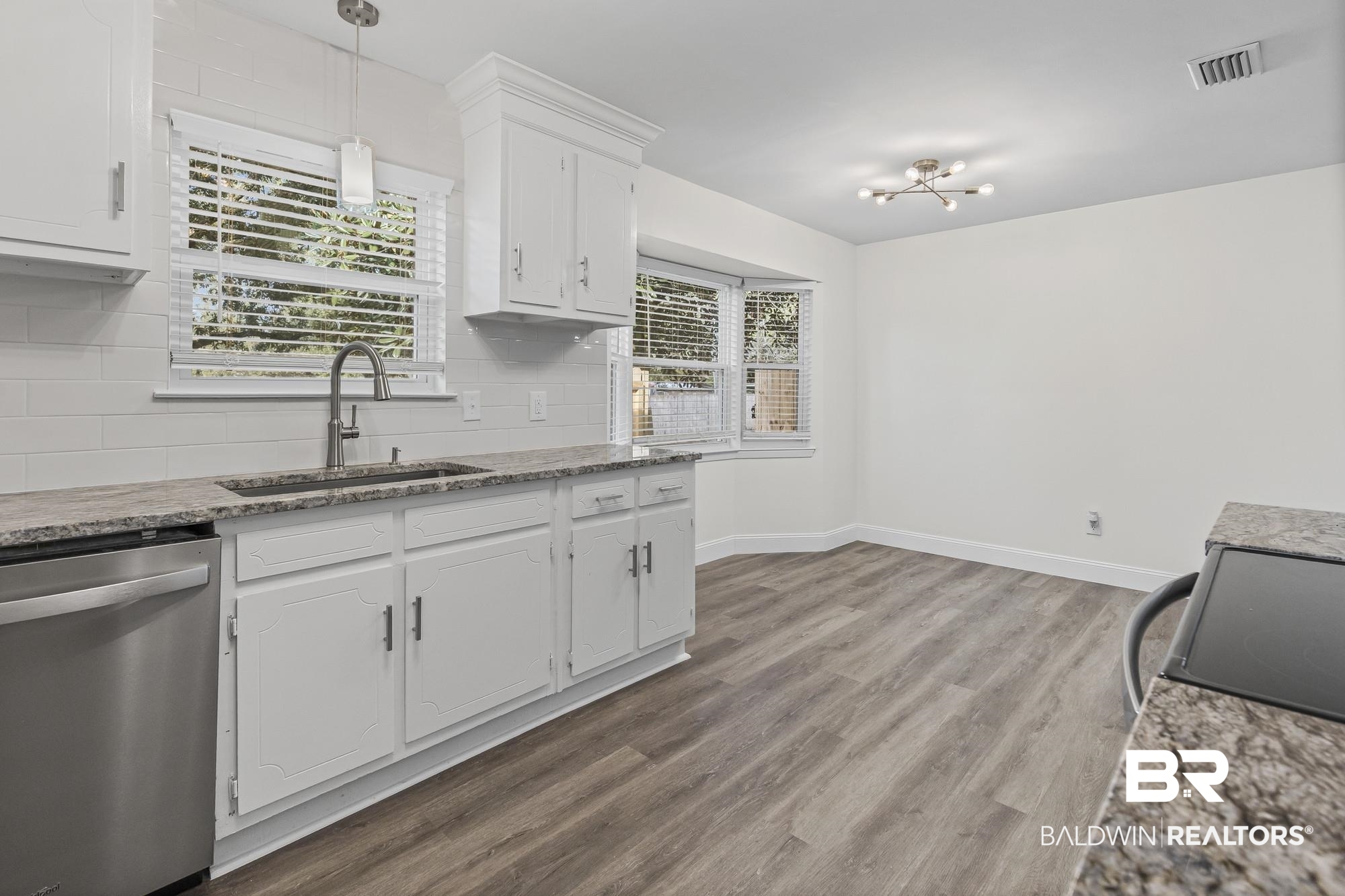 3041 Pretty Branch Drive East Mobile, AL 36618 - Photo 10 of 20 Kitchen featuring light stone countertops, stainless steel dishwasher, backsplash, and hanging light fixtures