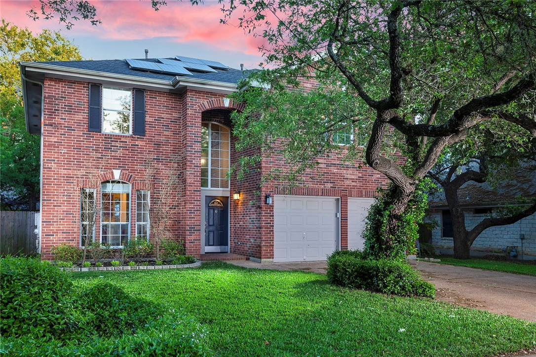 a front view of a house with garden