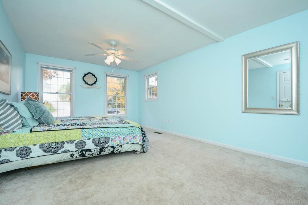 7 Magnolia Drive Ayer, MA 01432 - Photo 12 of 28 a bed sitting in a room next to a window