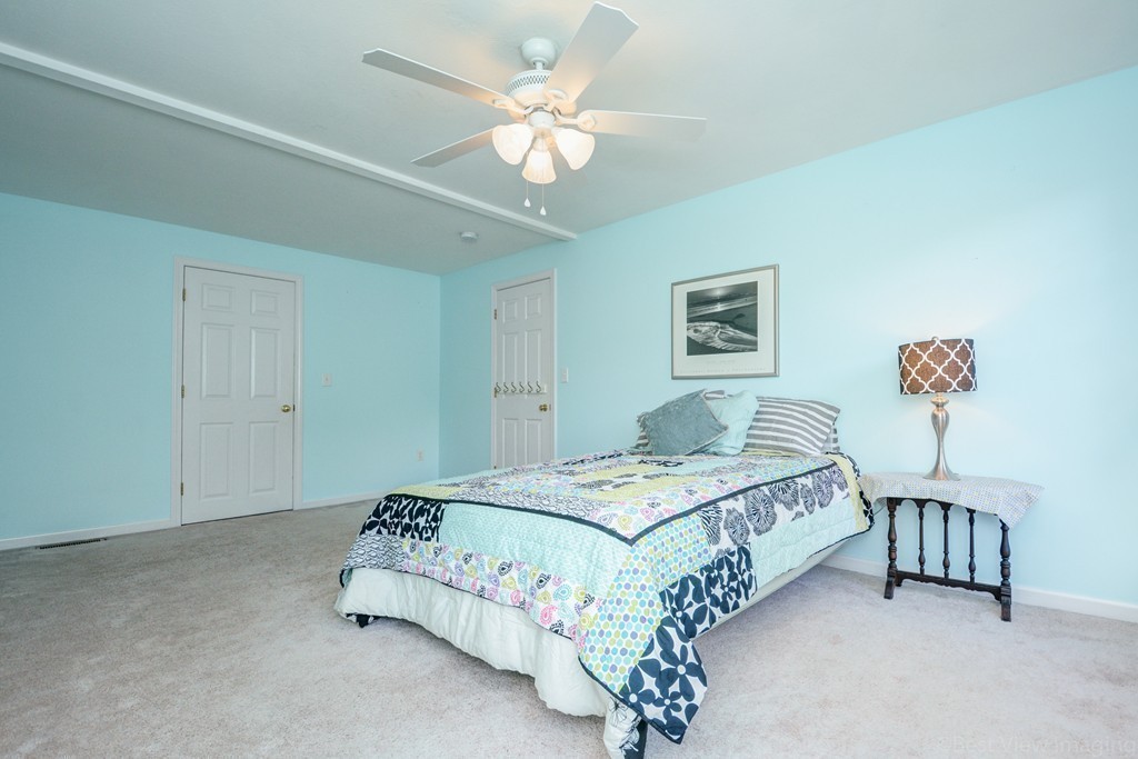 7 Magnolia Drive Ayer, MA 01432 - Photo 13 of 28 a bedroom with a bed and a chandelier
