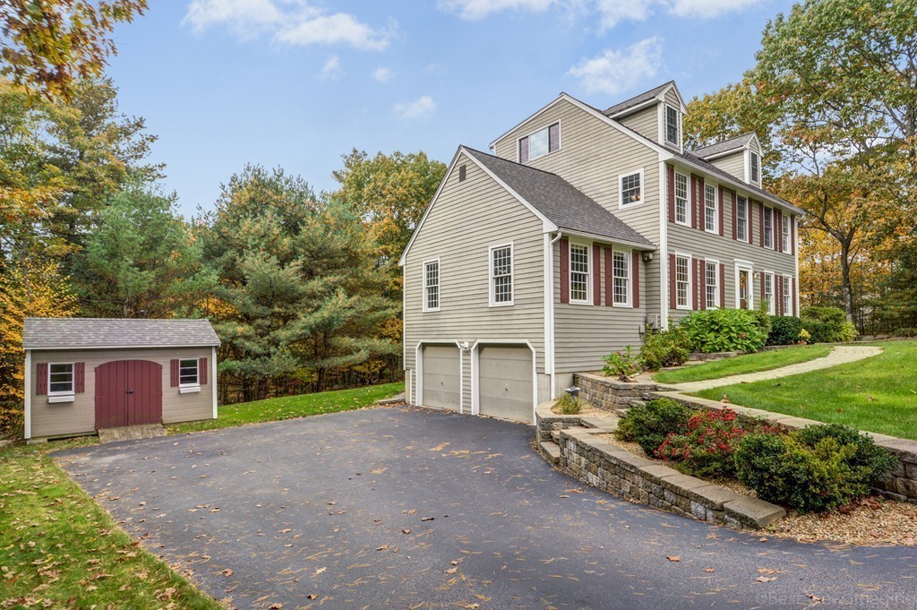 7 Magnolia Drive Ayer, MA 01432 - Photo 2 of 28 a front view of a house with garden