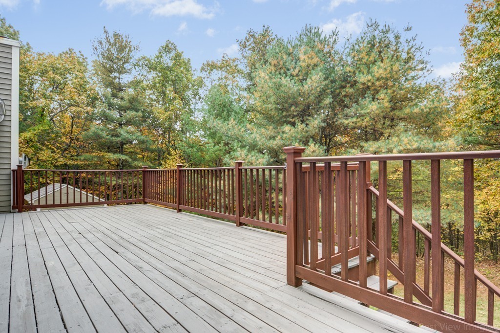 7 Magnolia Drive Ayer, MA 01432 - Photo 21 of 28 a balcony with wooden floor and fence