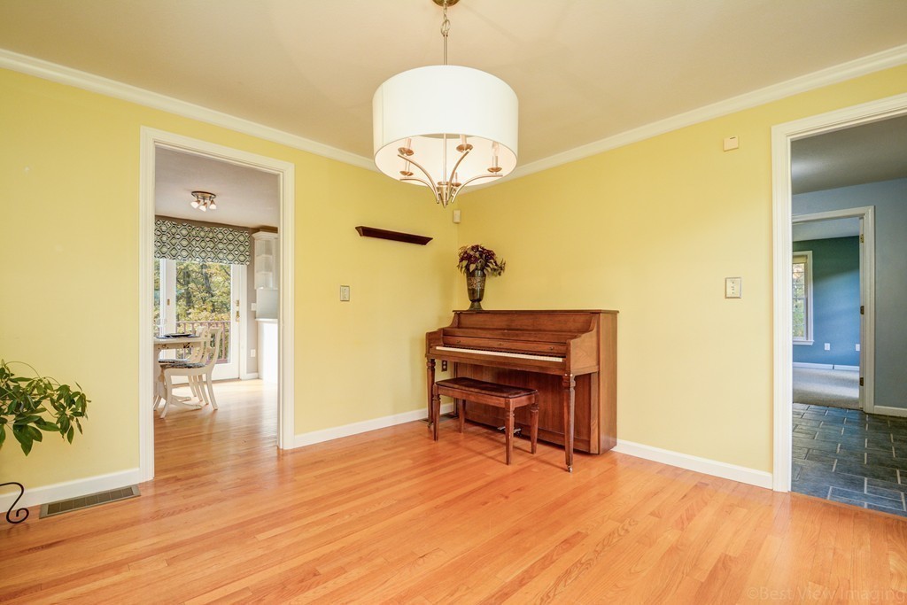 7 Magnolia Drive Ayer, MA 01432 - Photo 9 of 28 a room with a piano table and wooden floor
