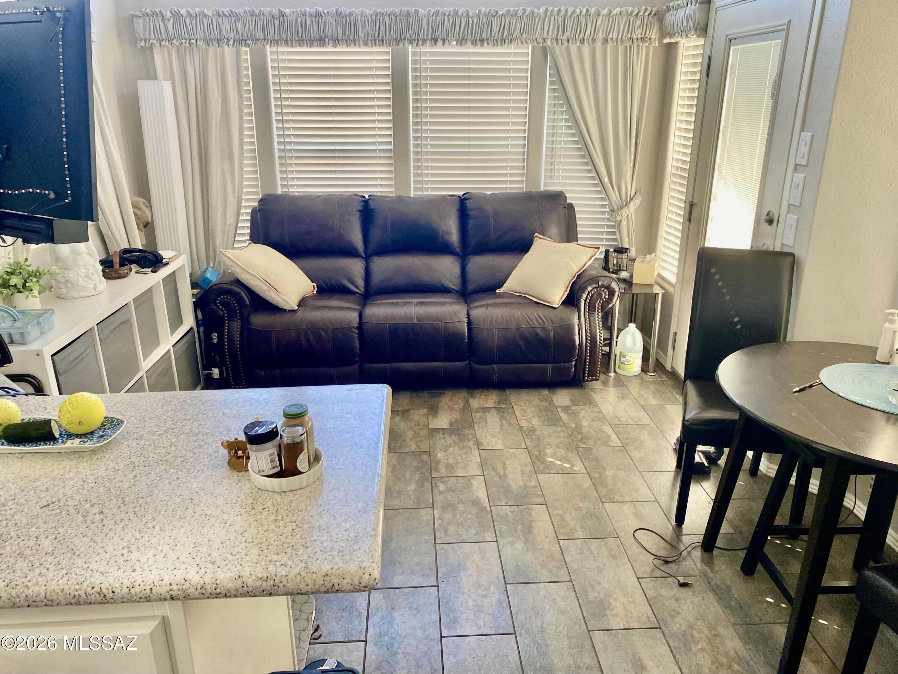 2843 19 Interstate 19 Frontage Road, Unit 116 Amado, AZ 85645 - Photo 10 of 32 a living room with furniture and a table