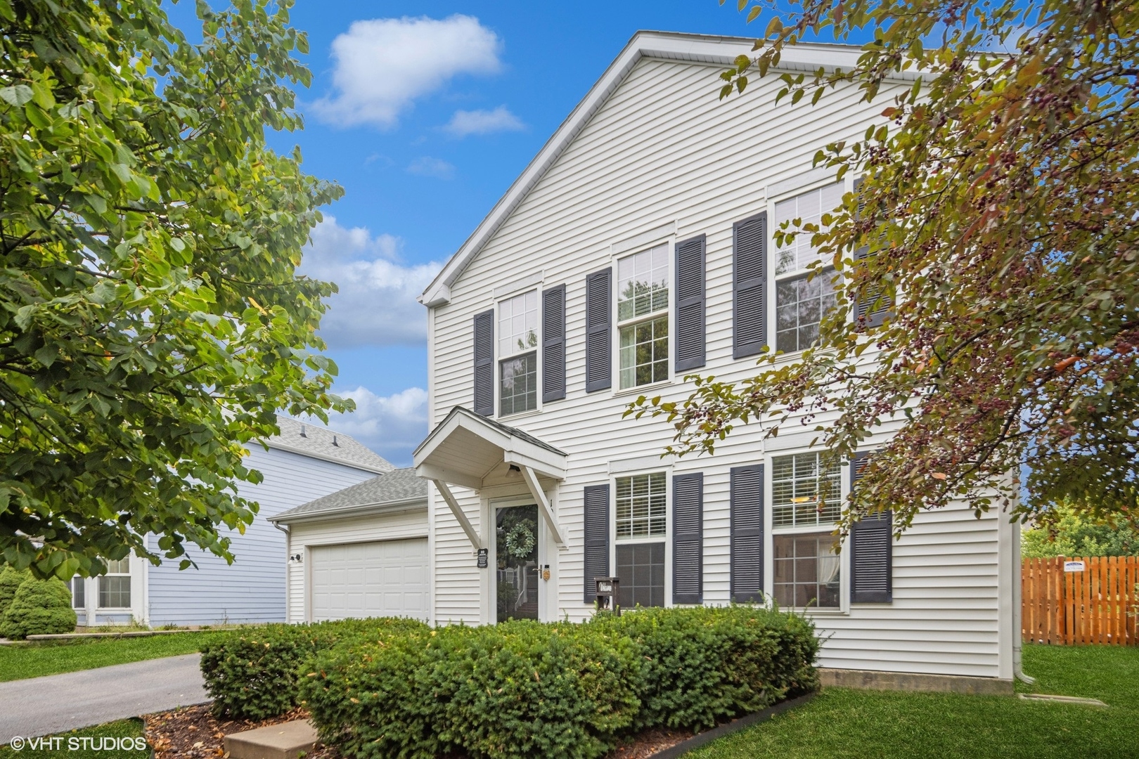 107 Eisenhower Drive Oswego, IL 60543 - Photo 1 of 22 a front view of a house with a garden