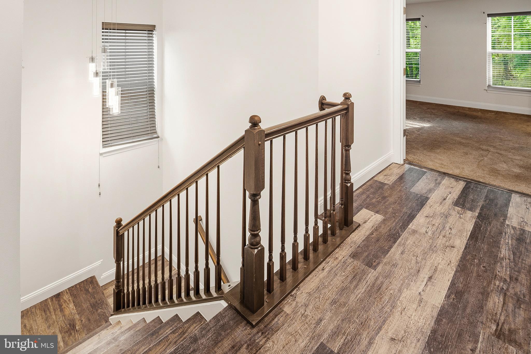 33 Greensborough Road Reisterstown, MD 21136 - Photo 27 of 40 a view of a hallway with wooden floor and stairs