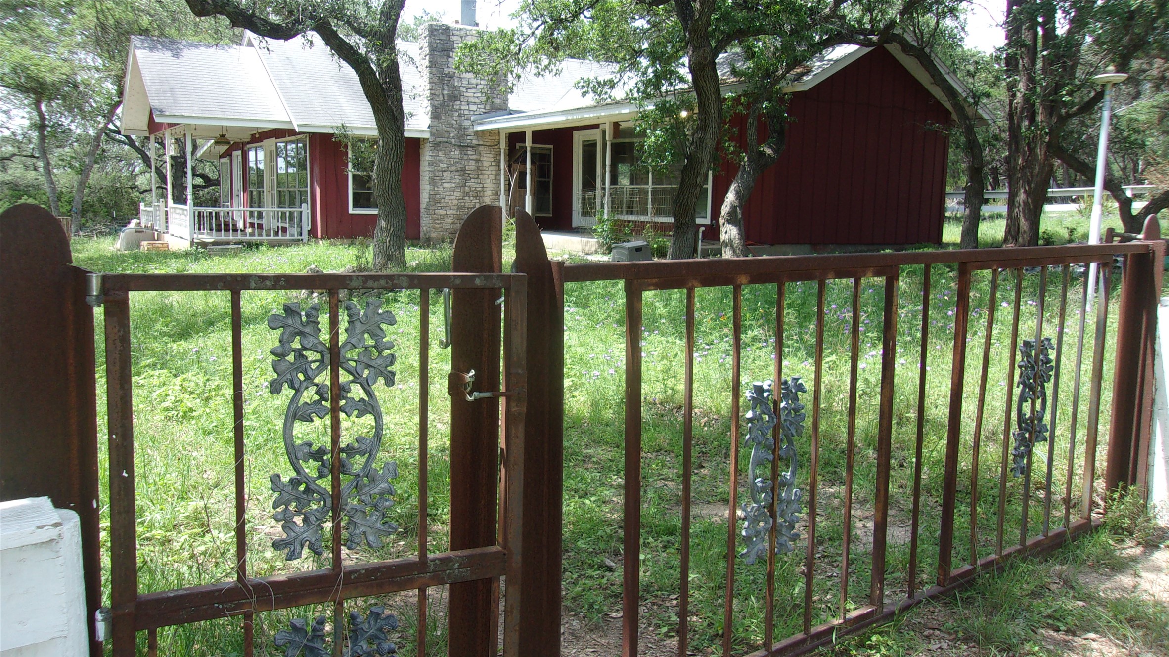 702 Cottonwood Creek Road Dripping Springs, TX 78620 - Photo 8 of 31 Wrought iron gate with decorative scrollwork