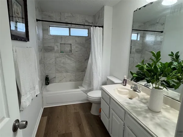 a bathroom with a sink a toilet and tub