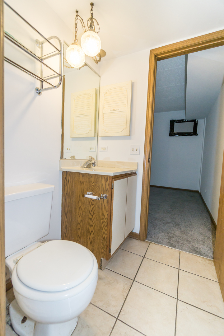 641 Briar Hill Lane, Unit 2 Addison, IL 60101 - Photo 11 of 16 a bathroom with a granite countertop sink toilet and shower