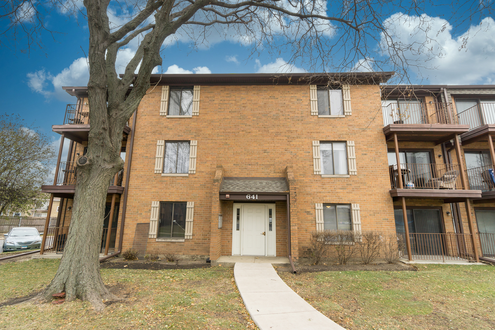 641 Briar Hill Lane, Unit 2 Addison, IL 60101 - Photo 2 of 16 a front view of a house with a yard