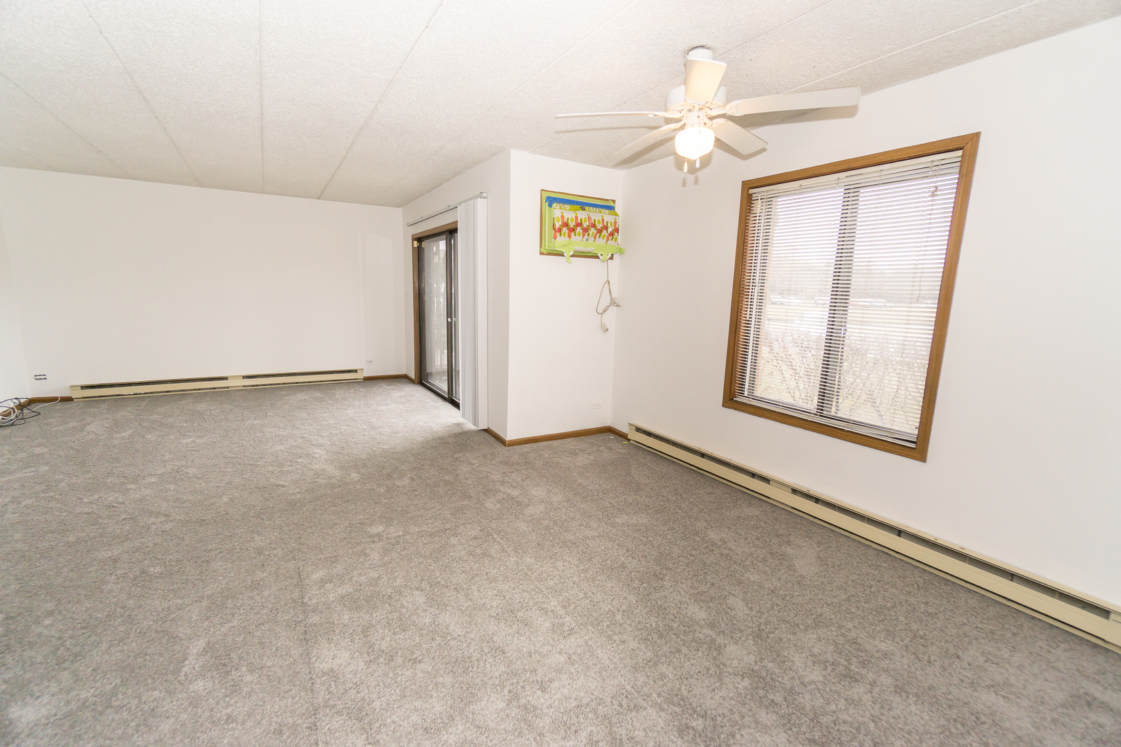 641 Briar Hill Lane, Unit 2 Addison, IL 60101 - Photo 3 of 16 an empty room with windows and fan