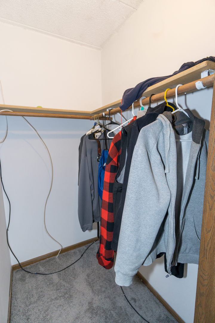 641 Briar Hill Lane, Unit 2 Addison, IL 60101 - Photo 10 of 16 a view of walk in closet with clothes and shoes