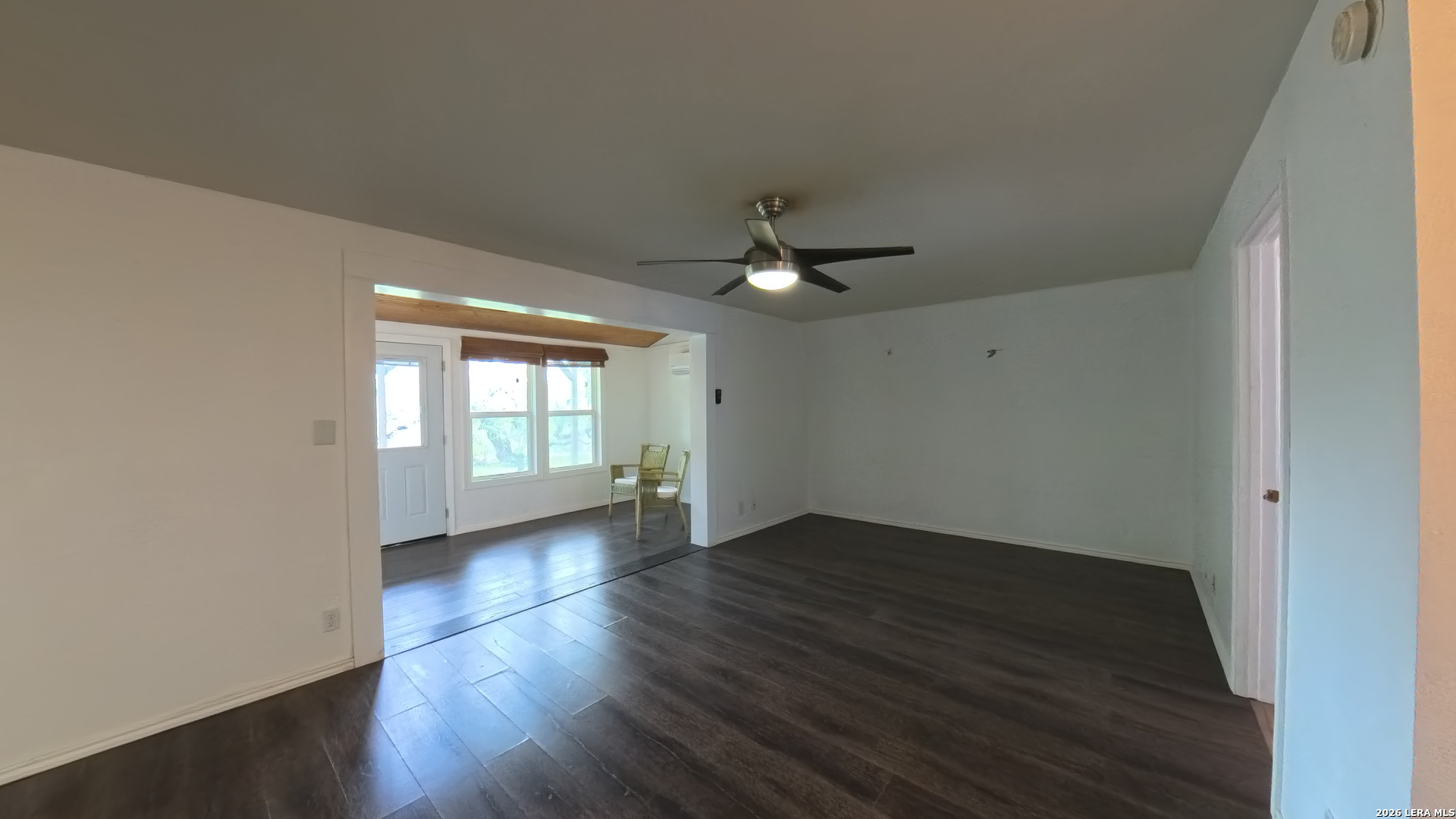 929 Red Bluff Ranch Drive Pipe Creek, TX 78063 - Photo 6 of 43 a view of an empty room with wooden floor and a window