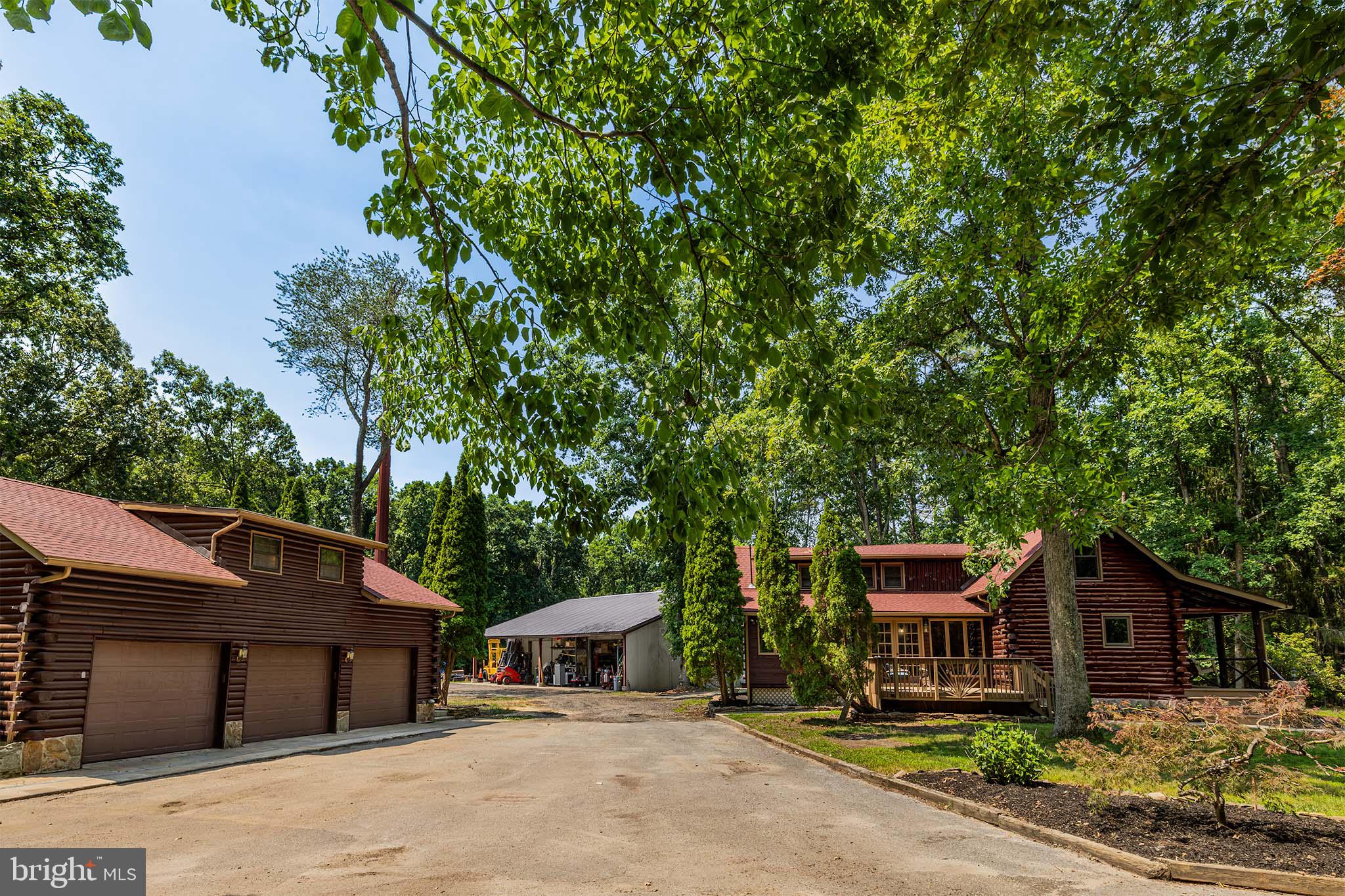 a front view of a house with a garden and parking