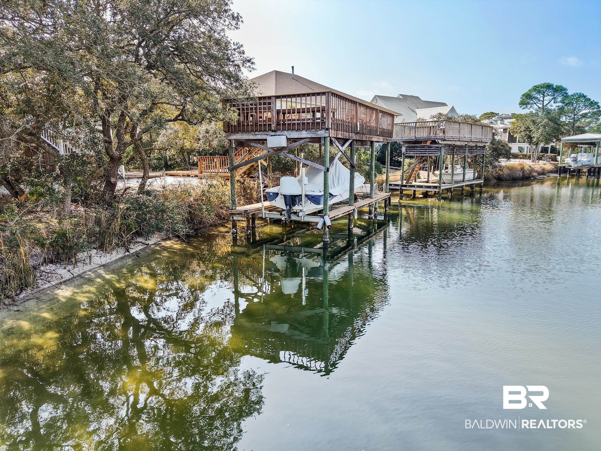 32191 River Road Orange Beach, AL 36561 - Photo 44 of 46 Dock featuring boat lift and a deck with water view