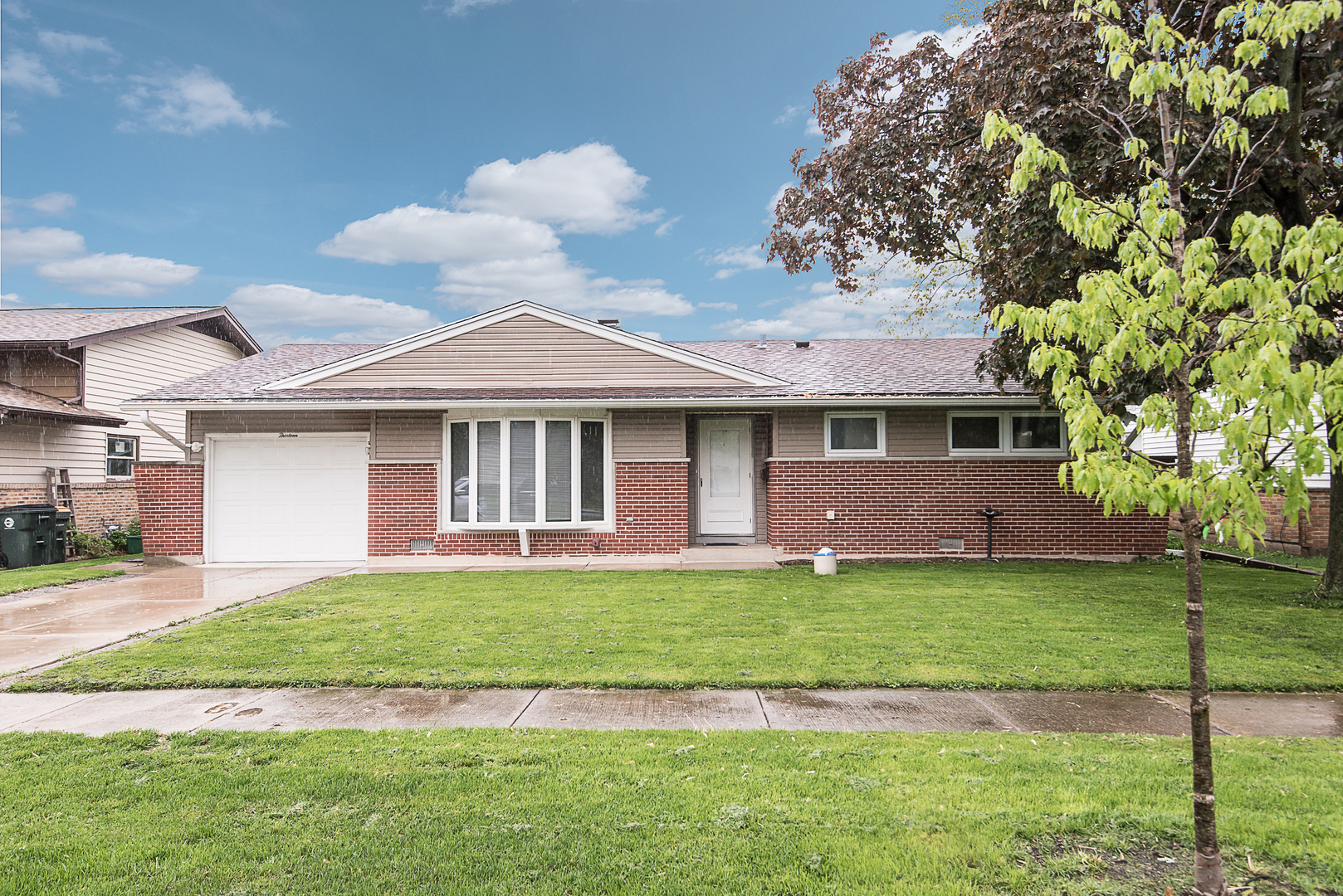 13 Wildwood Road Elk Grove Village, IL 60007 - Photo 1 of 23 a front view of a house with a garden and yard