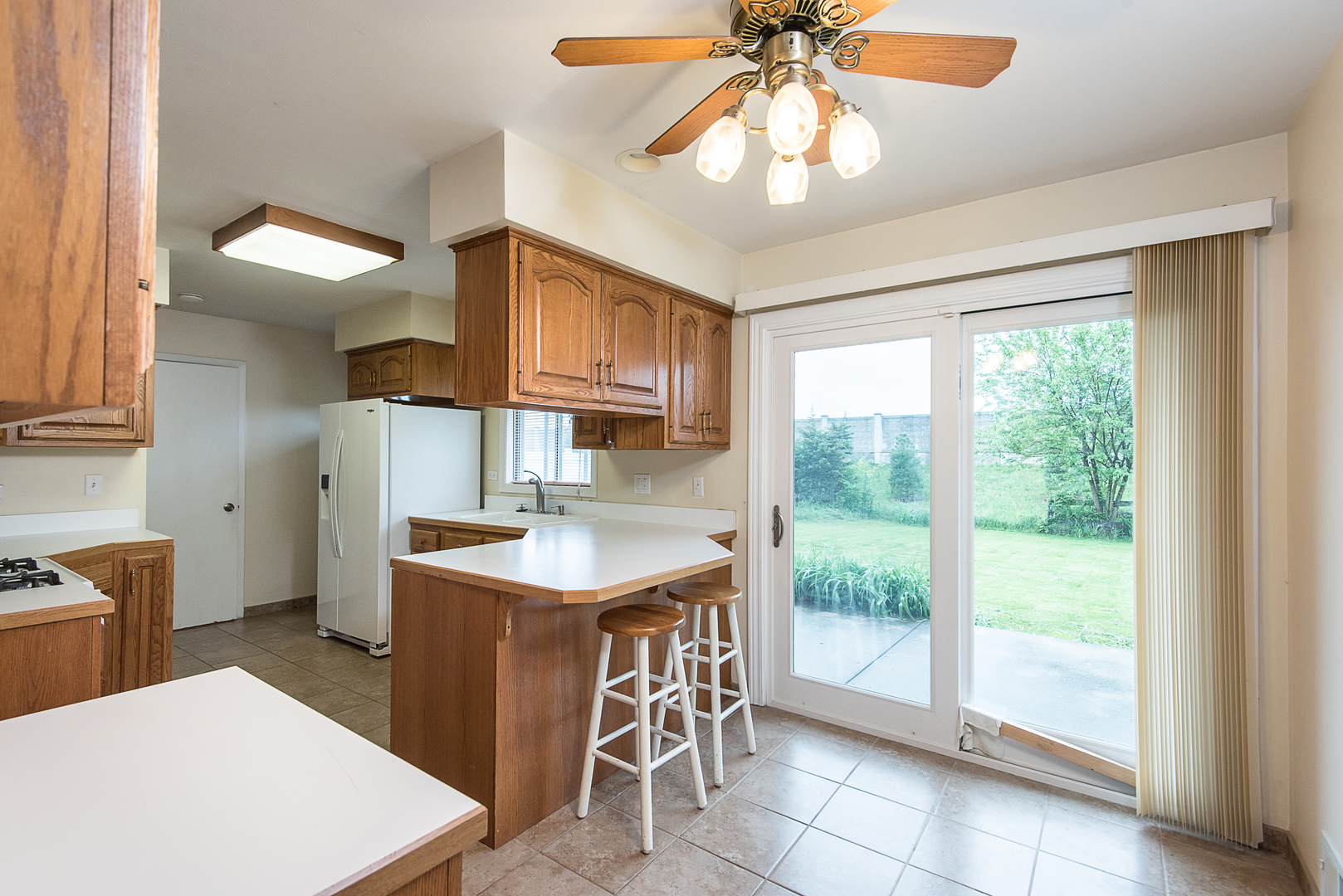13 Wildwood Road Elk Grove Village, IL 60007 - Photo 13 of 23 a kitchen with a stove a sink a dining table and chairs