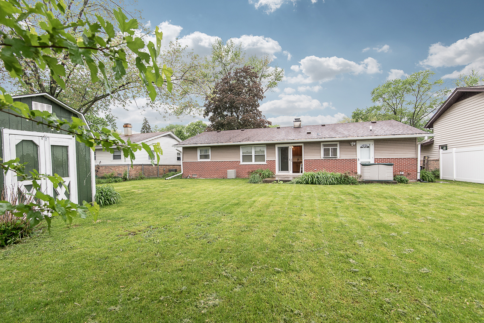 13 Wildwood Road Elk Grove Village, IL 60007 - Photo 4 of 23 a front view of a house with a garden