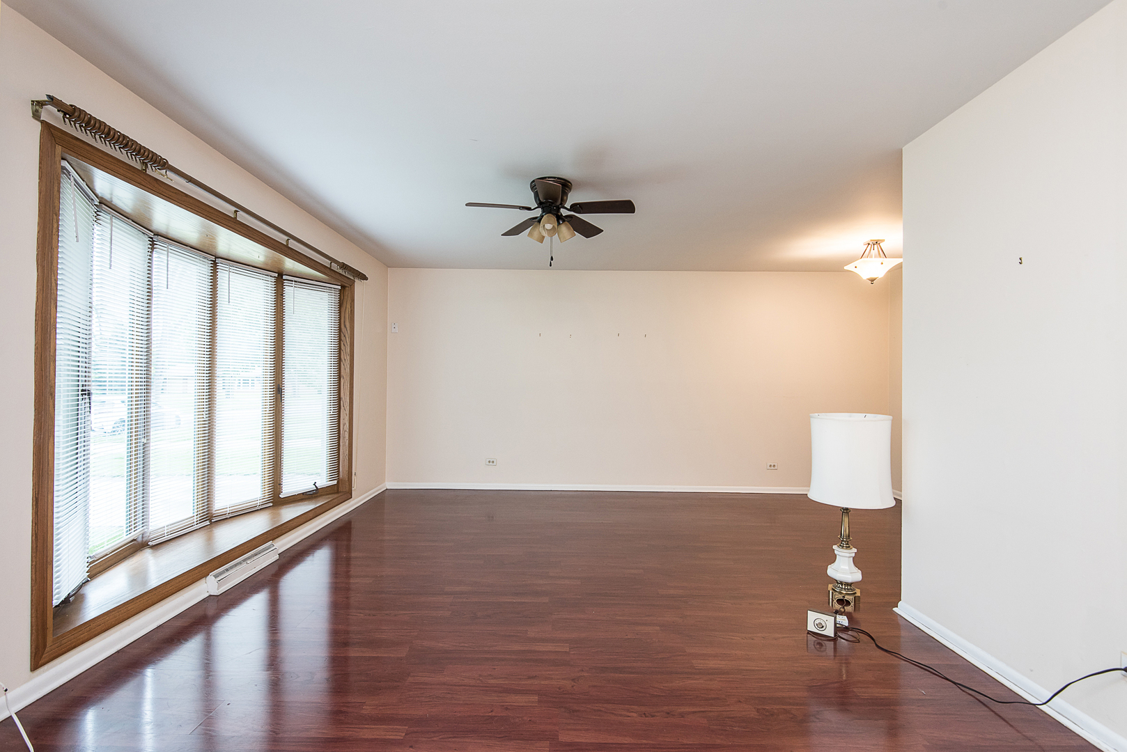 13 Wildwood Road Elk Grove Village, IL 60007 - Photo 7 of 23 wooden floor in an empty room with a window