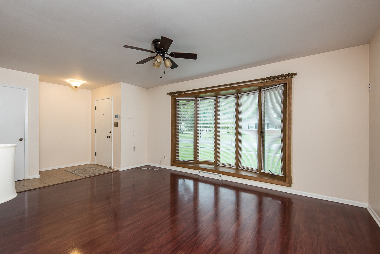 13 Wildwood Road Elk Grove Village, IL 60007 - Photo 8 of 23 a view of an empty room with wooden floor and a window