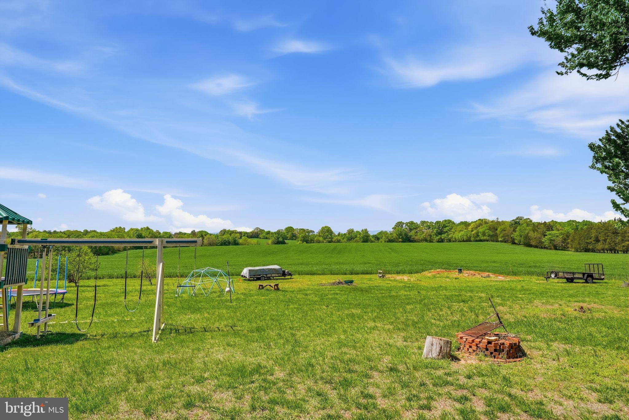 11844 Cemetery Road Remington, VA 22734 - Photo 12 of 13 Sprawling green fields under blue skies.