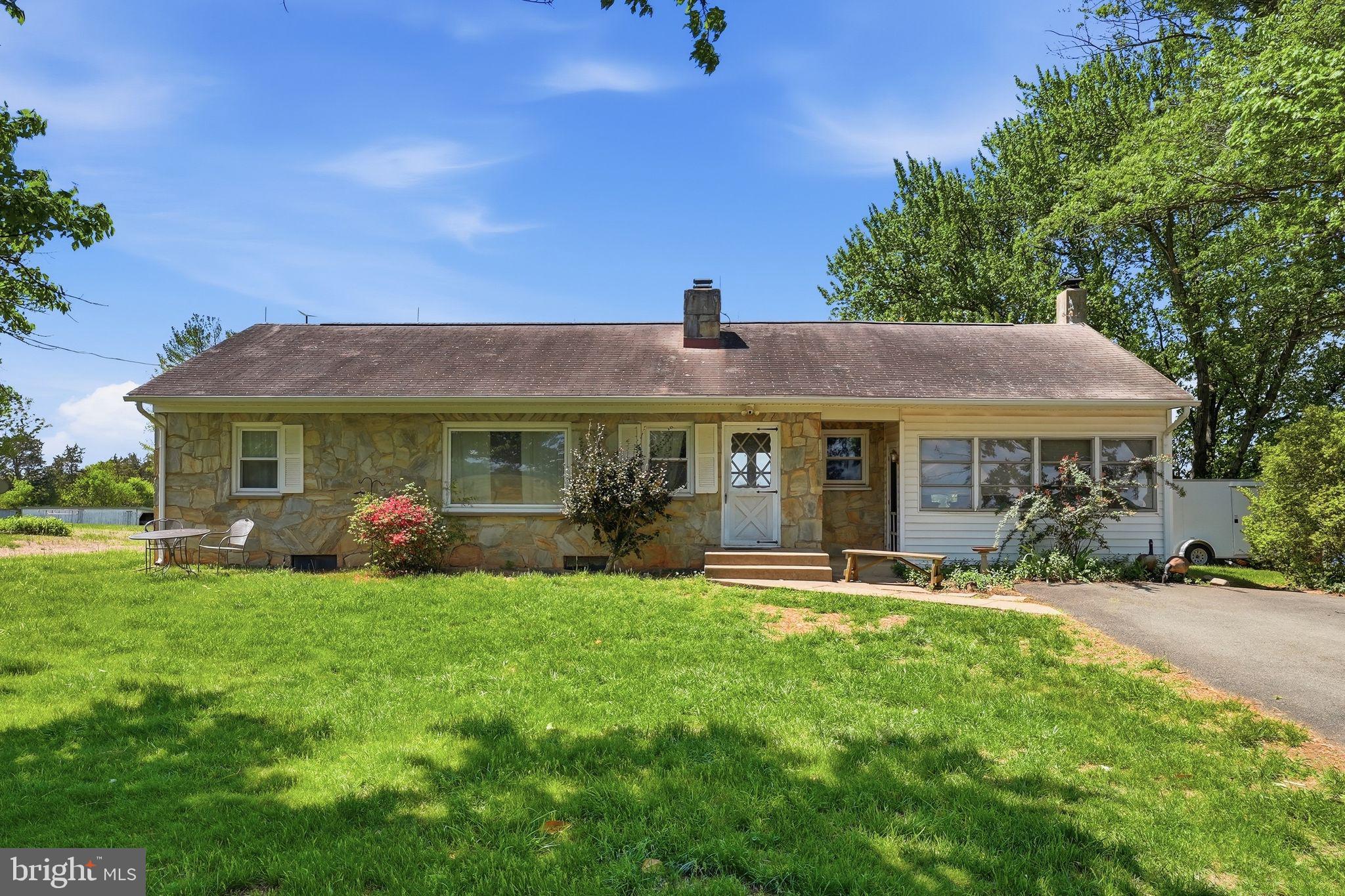 11844 Cemetery Road Remington, VA 22734 - Photo 3 of 13 Charming stone home with lush greenery.