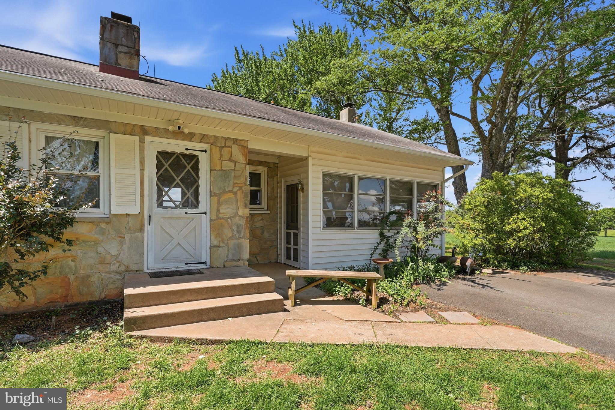 11844 Cemetery Road Remington, VA 22734 - Photo 5 of 13 Charming stone facade with lush greenery.