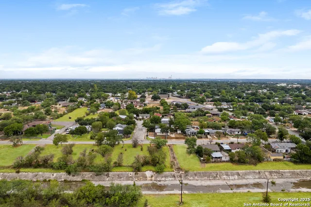 an aerial view of residential houses with outdoor space